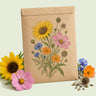 Kraft seed packet illustrated with Songbird Flower Mix, with fresh Songbird Flower Mix beside it