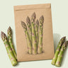 Kraft seed packet illustrated with Spartacus Asparagus, with fresh Spartacus Asparagus beside it