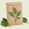 Kraft seed packet illustrated with Spinach Baby Greens, with fresh Spinach Baby Greens beside it