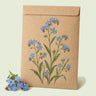 Kraft seed packet illustrated with Spring and Summer Forget-Me-Not Mix, with fresh Spring and Summer Forget-Me-Not Mix beside it