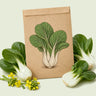 Kraft seed packet illustrated with Toy Choy Mini Bok Choy, with fresh Toy Choy Mini Bok Choy beside it