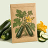Kraft seed packet illustrated with Triumph Zucchini, with fresh Triumph Zucchini beside it