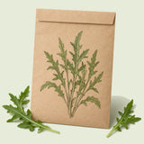 Kraft seed packet illustrated with Wild Rocket Arugula, with fresh Wild Rocket Arugula beside it
