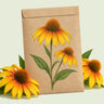 Kraft seed packet illustrated with Yellow Ombre Echinacea, with fresh Yellow Ombre Echinacea beside it