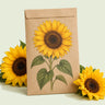 Kraft seed packet illustrated with Zohar Golden Sunflower, with fresh Zohar Golden Sunflower beside it